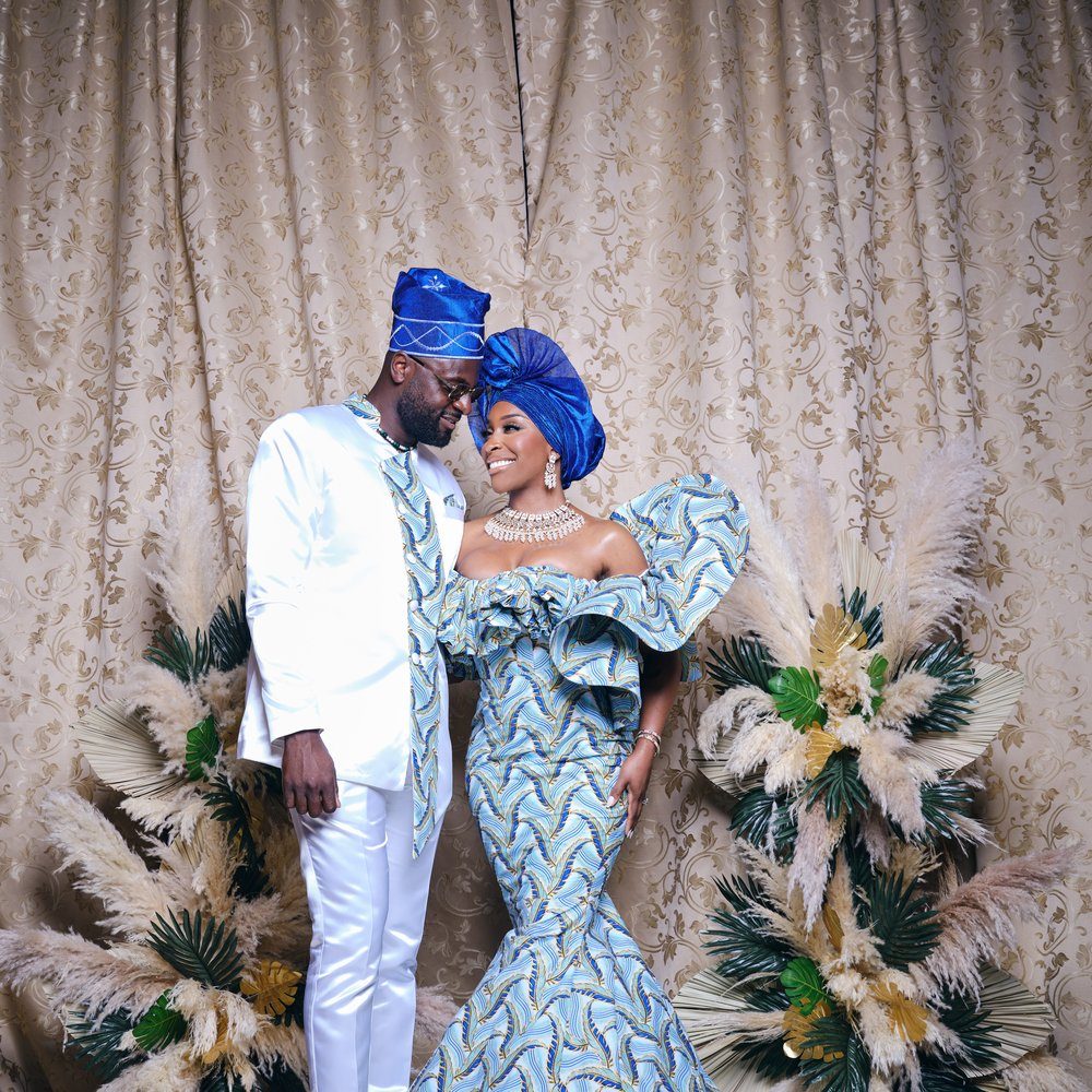 Couple in matching blue and white traditional attire at an Amplify Africa event